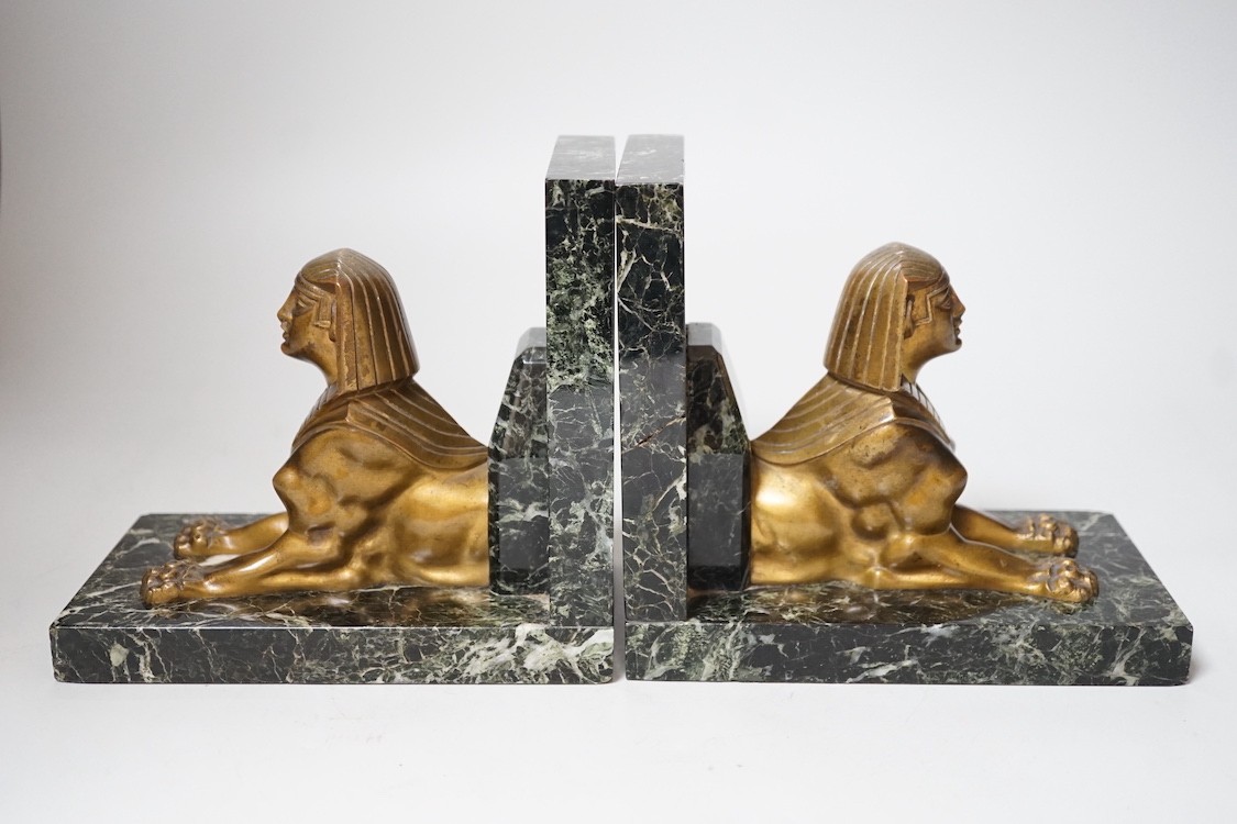 A pair of Art Deco bronze and serpentine 'sphinx' bookends, 17cms wide x 15.5cms high